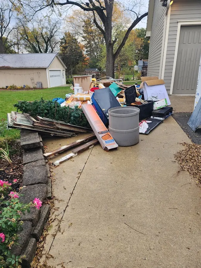 Dumpster being loaded with debris for Roofing Dumpster Rental in Forest Park